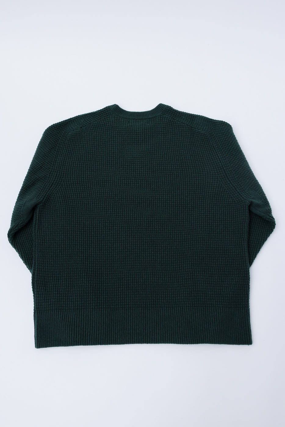 Flat lay of Merz b. Schwanen waffle knit pullover in bottle green, back side, ribbed hem, crewneck.