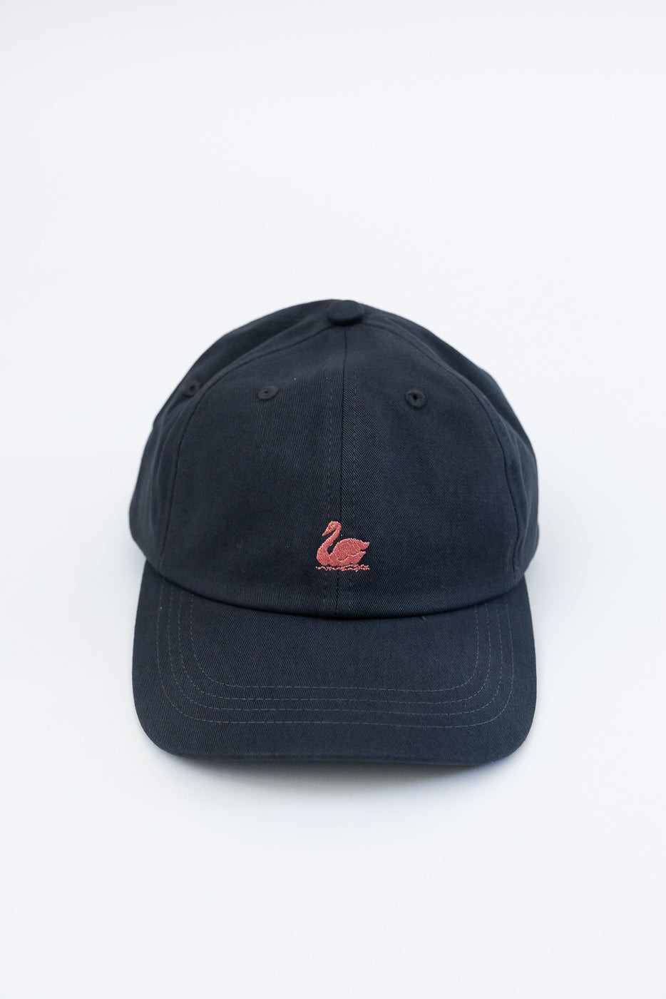 Front view close-up of charcoal cotton twill cap with rosewood swan logo embroidery.