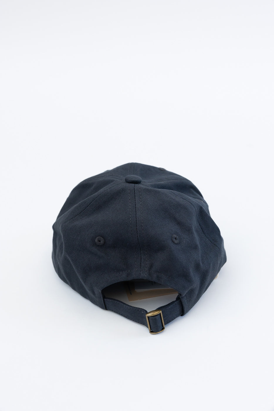 Back view close-up of charcoal cotton twill cap showing adjustable strap and fabric texture