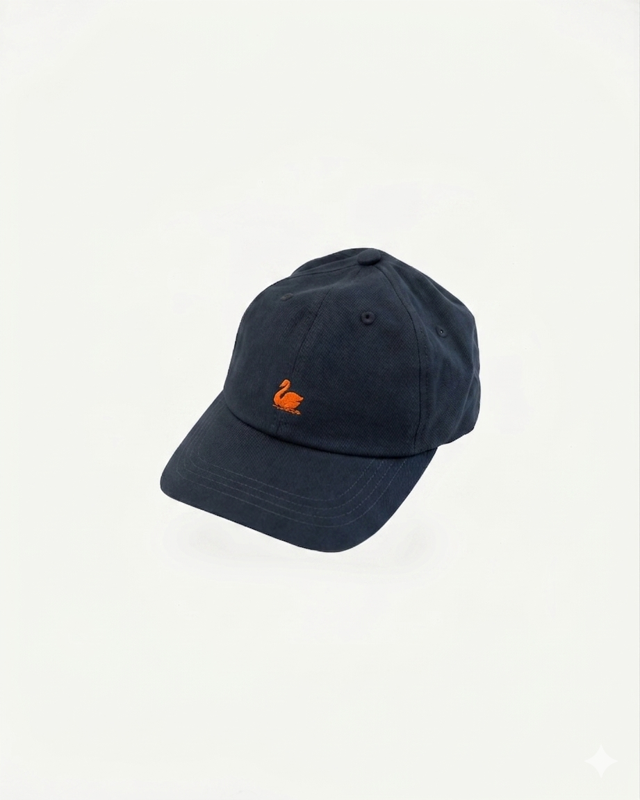 Front view close-up of night blue cotton twill cap with orange swan logo embroidery.