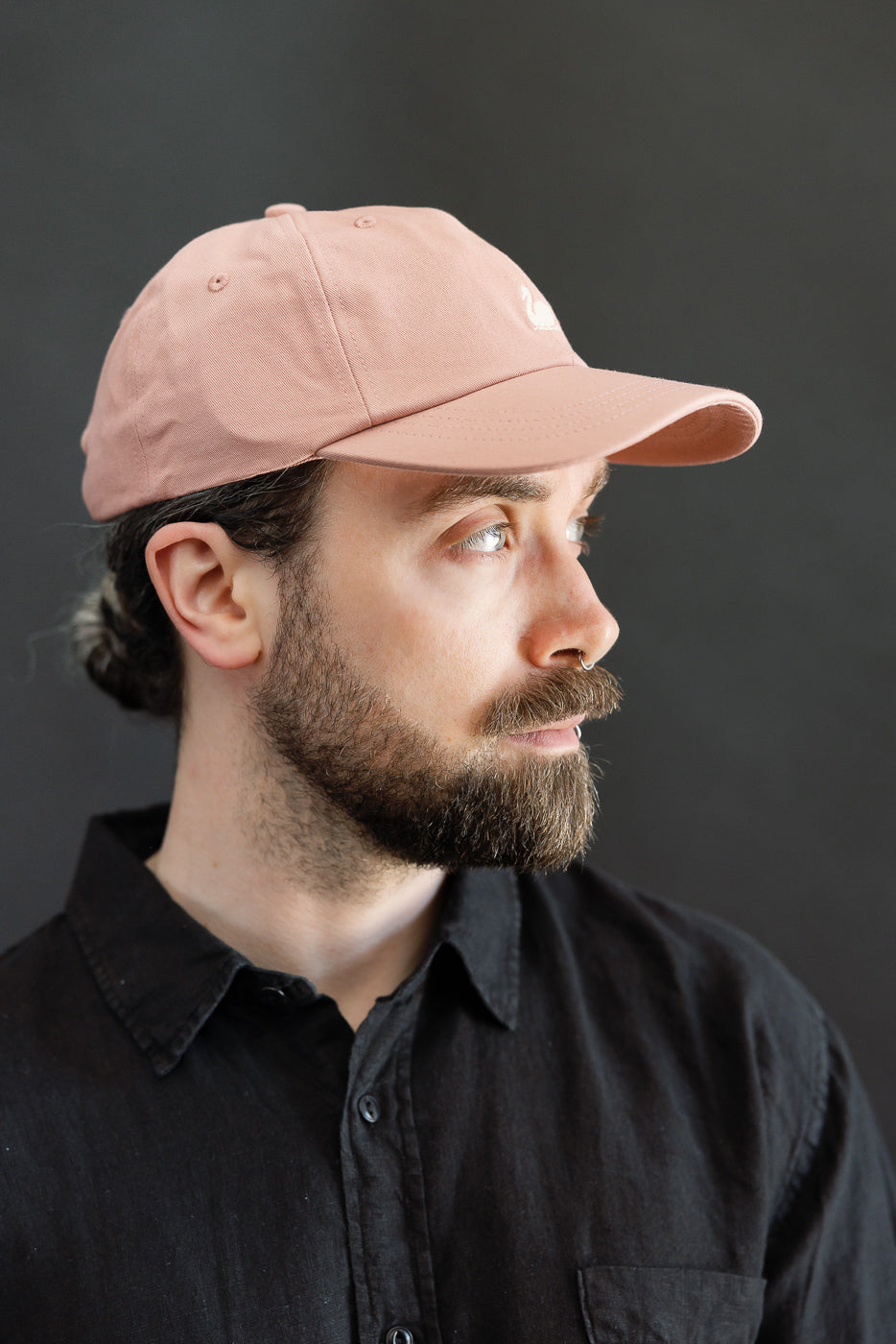 Close-up side view of rosewood cotton twill cap on male model, 5'9