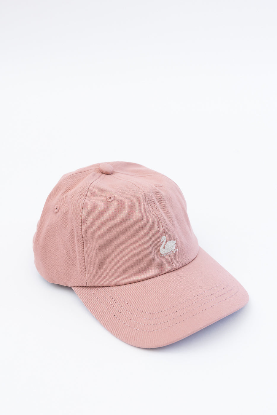 Front angled close-up of rosewood cotton twill cap with embroidered swan logo.