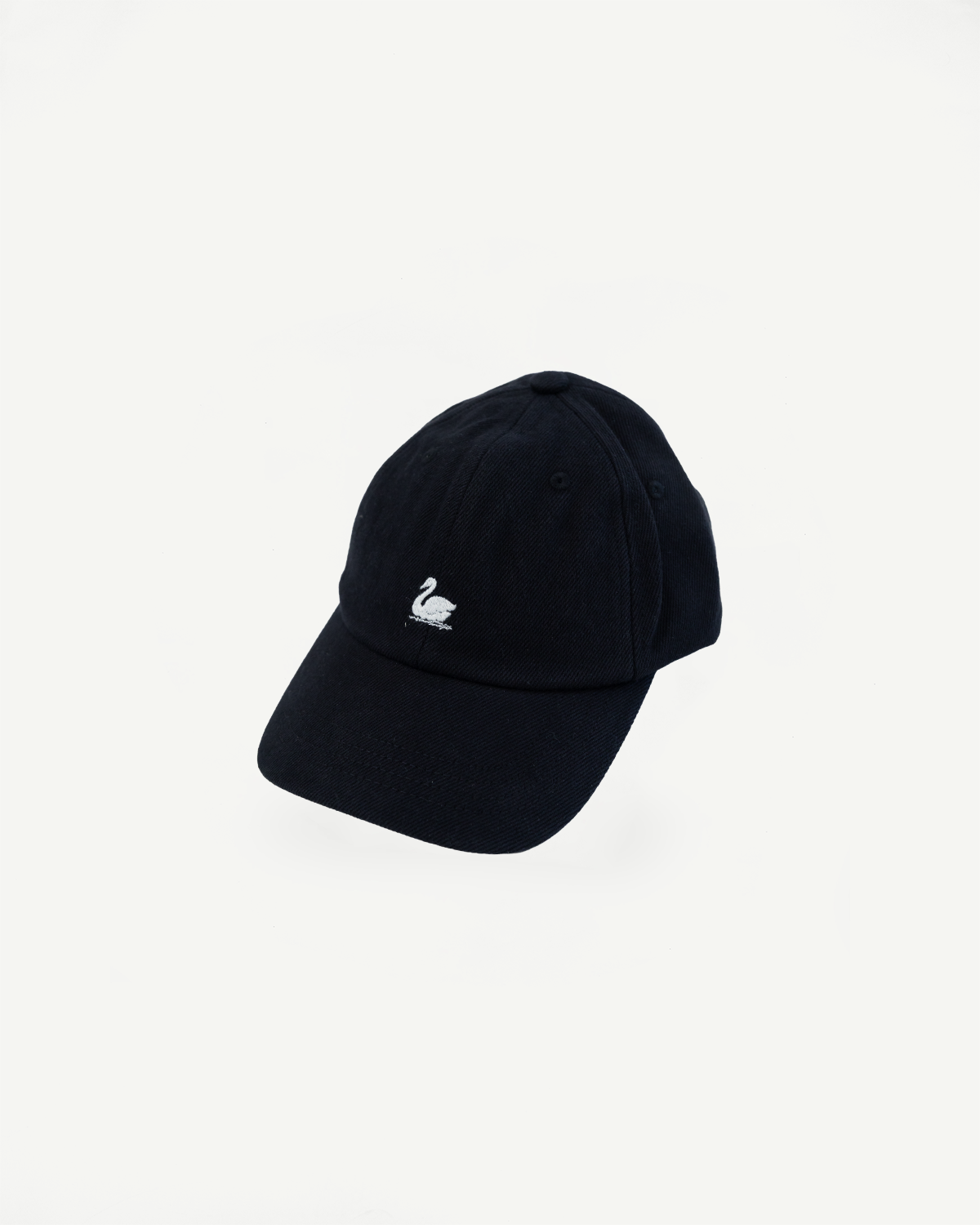 Front flat lay of deep black cotton twill cap, curved brim, white swan logo embroidered.