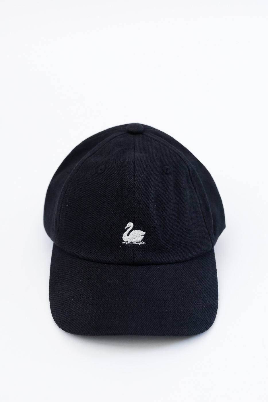 Front close-up of black cotton twill cap with white swan embroidered logo