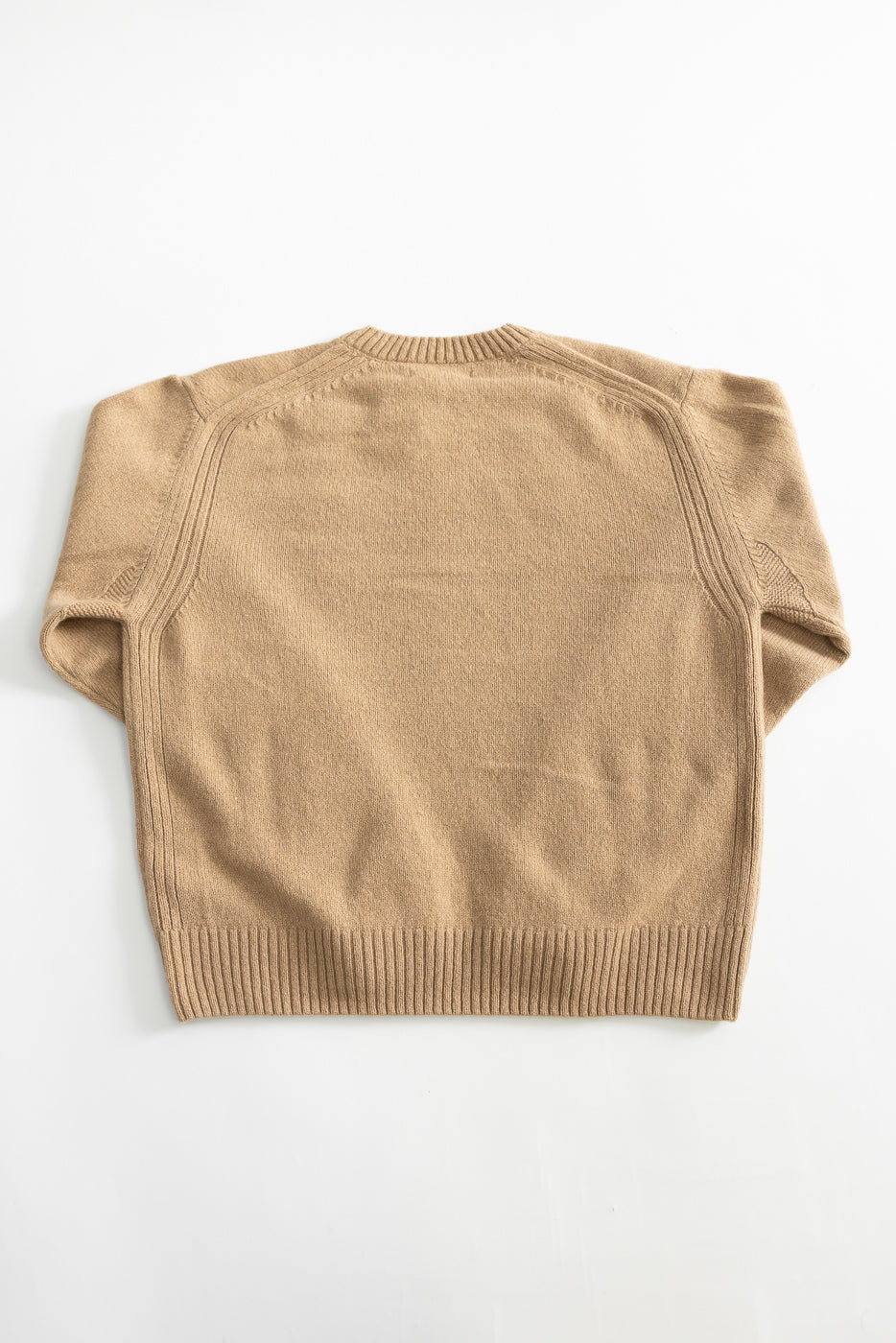 Flat lay of recycled cashmere sweater in toffee, back view, showing ribbed hem and raglan seams