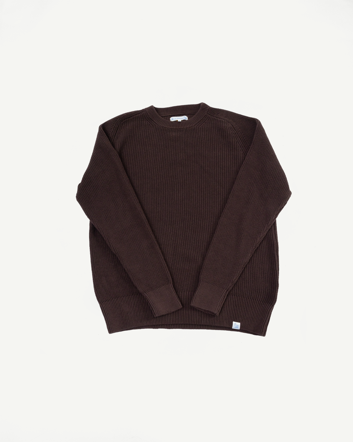 Front view flat lay of a dark brown ribbed knit crewneck sweater.