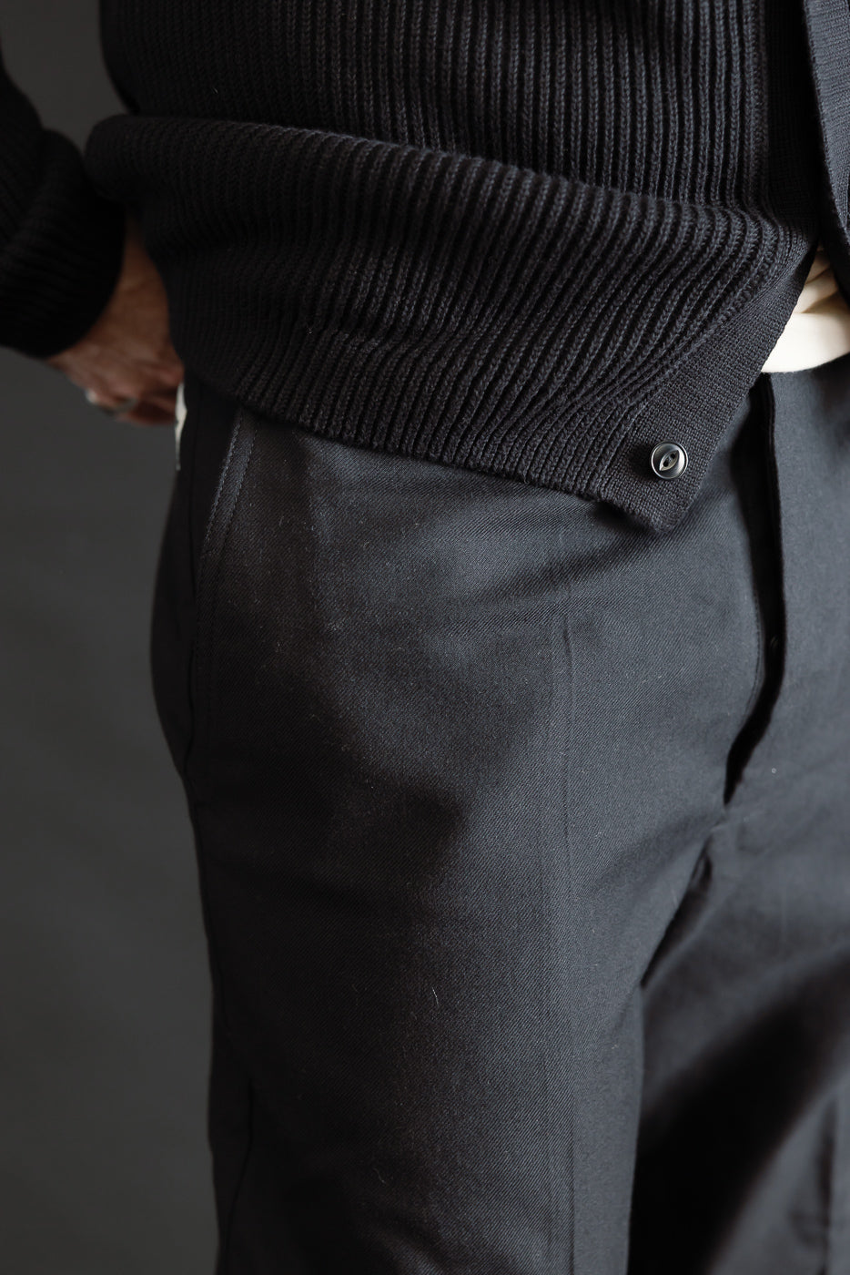 Close-up front side view of deep black wool cotton chinos on male model, 5'9