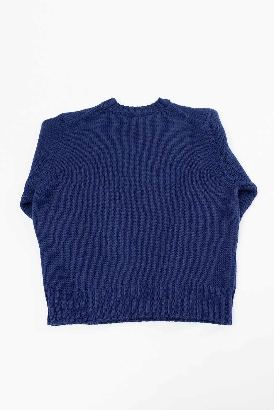 Back view flat lay of a navy blue knit crewneck sweater.