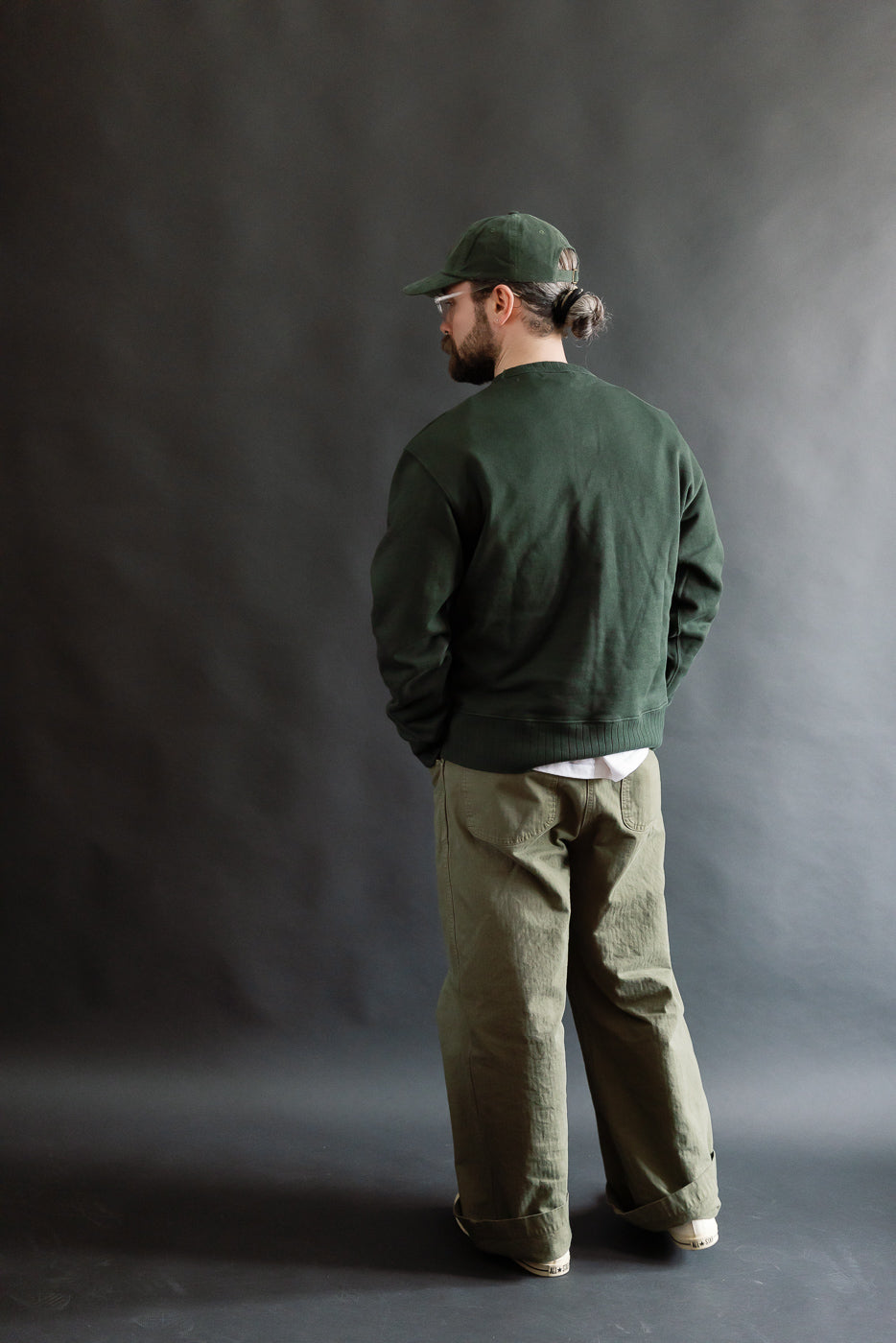 Male model 5'9 165lbs athletic build wearing forest green heavyweight cotton sweatshirt, back view full body