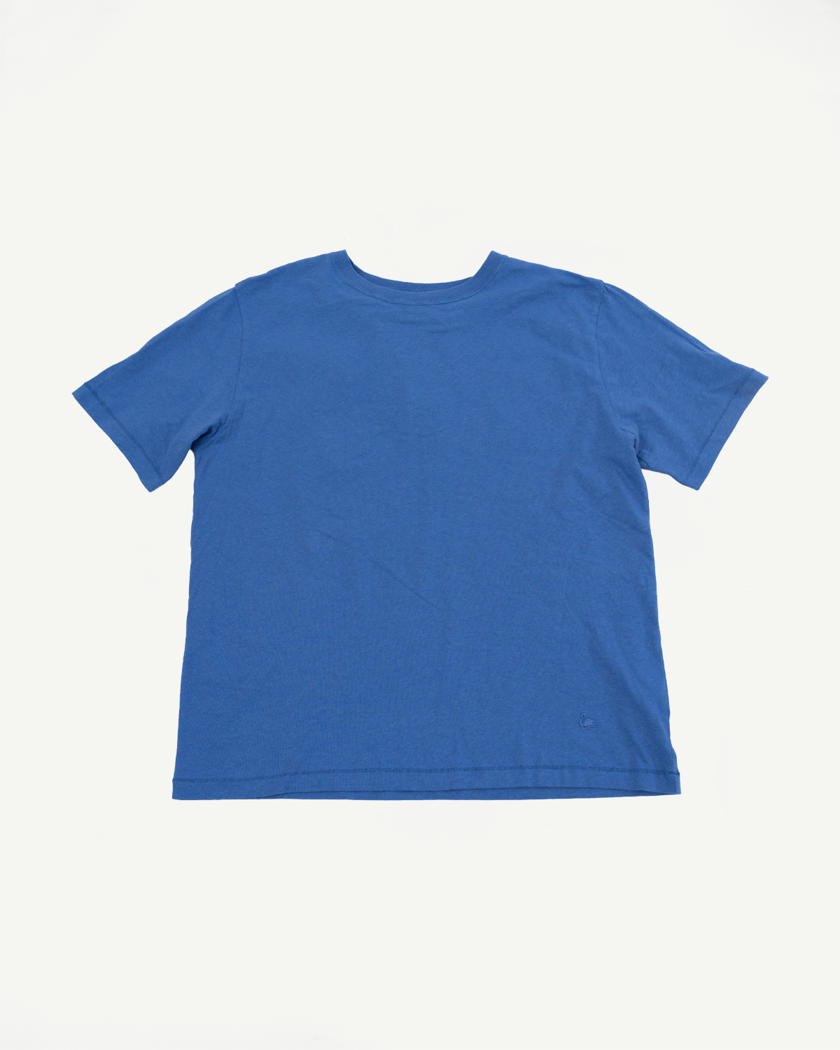 Flat lay of faded blue cotton hemp t-shirt, back side, showing short sleeves and crew neck.