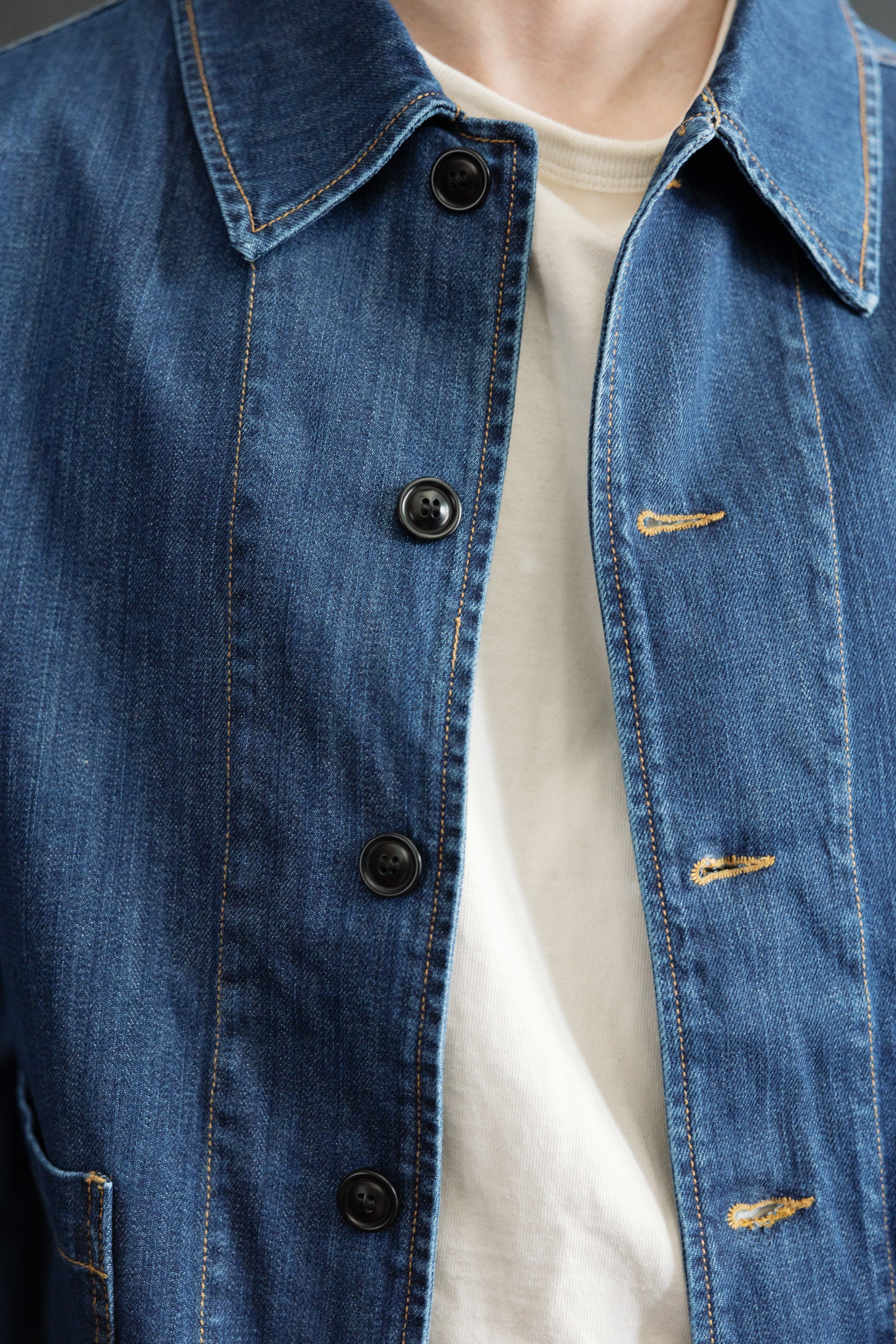 Close-up front of men's denim jacket on male model, 5'9