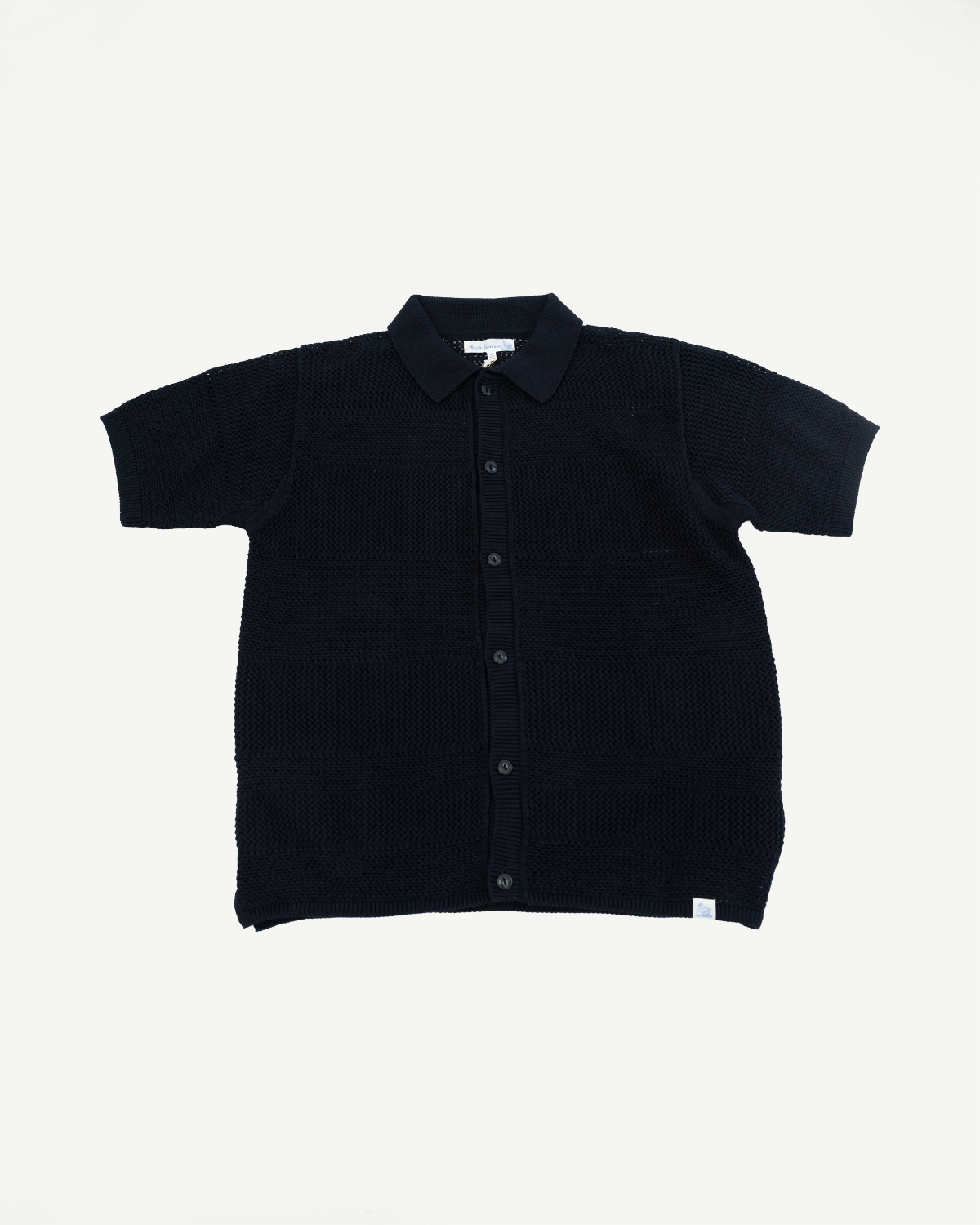 Flat lay front view of black crochet cotton short sleeve knit shirt with buttons and spread collar.