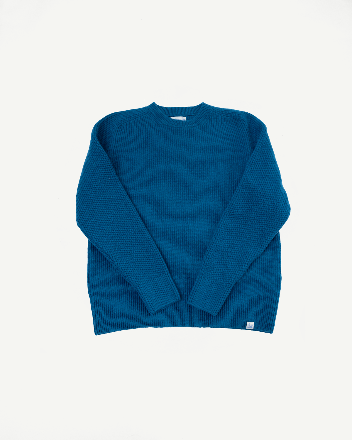 Front view flat lay of a blue ribbed knit sweater with long sleeves and a crew neck.