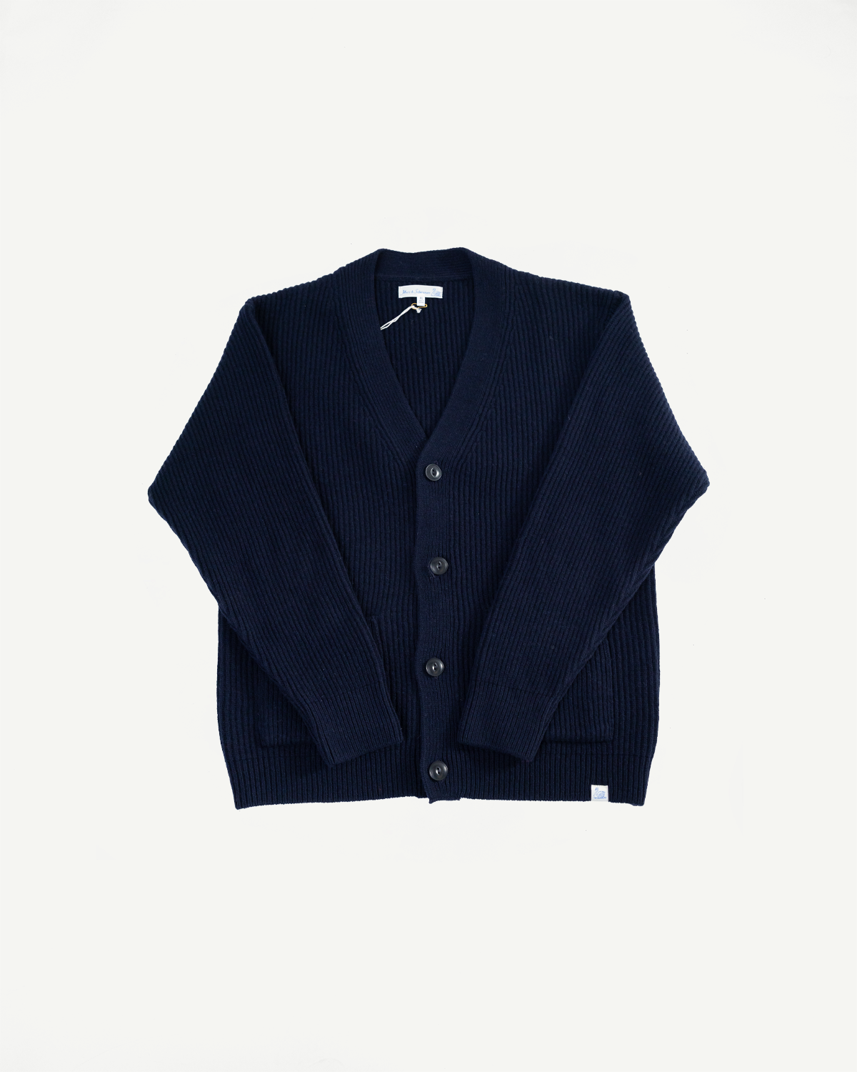 Front flat lay of navy Merz b. Schwanen merino wool cashmere cardigan, button detail visible