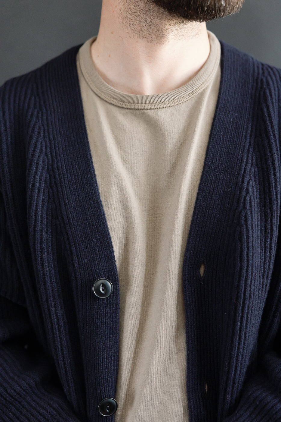 Close-up front view of navy Merz b. Schwanen merino wool cashmere cardigan on male model, 5'9