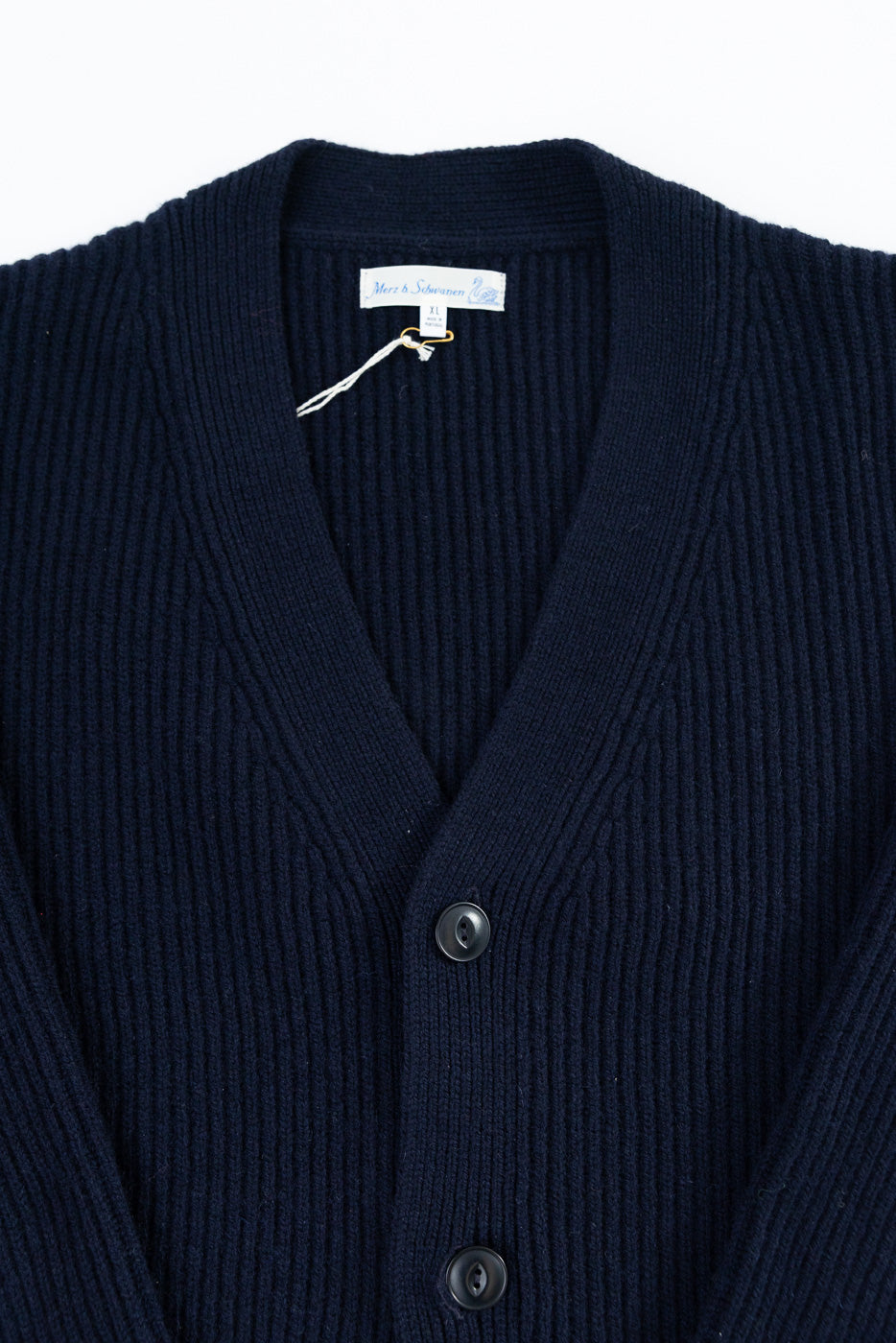 Close-up front view of Merz b. Schwanen navy ribbed merino wool cashmere cardigan, showing buttons and V-neck collar detail.