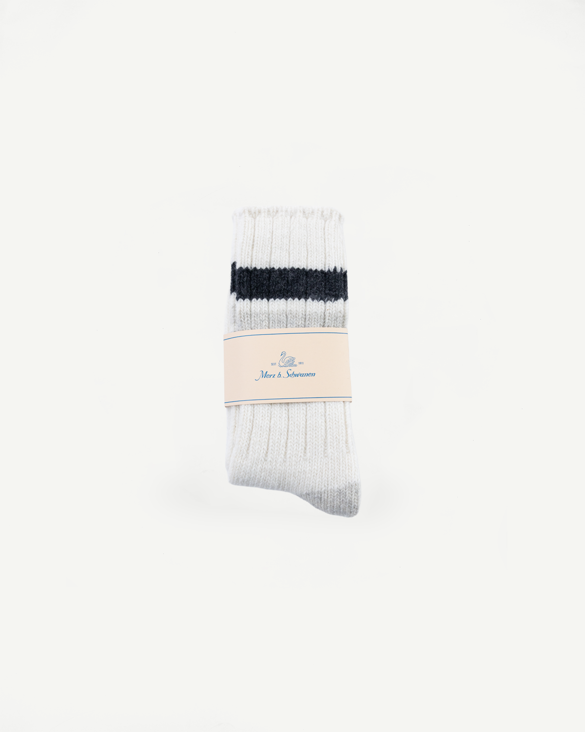 Front flat lay of Merz b. Schwanen recycled wool socks in nature and charcoal, ribbed texture, packaging visible