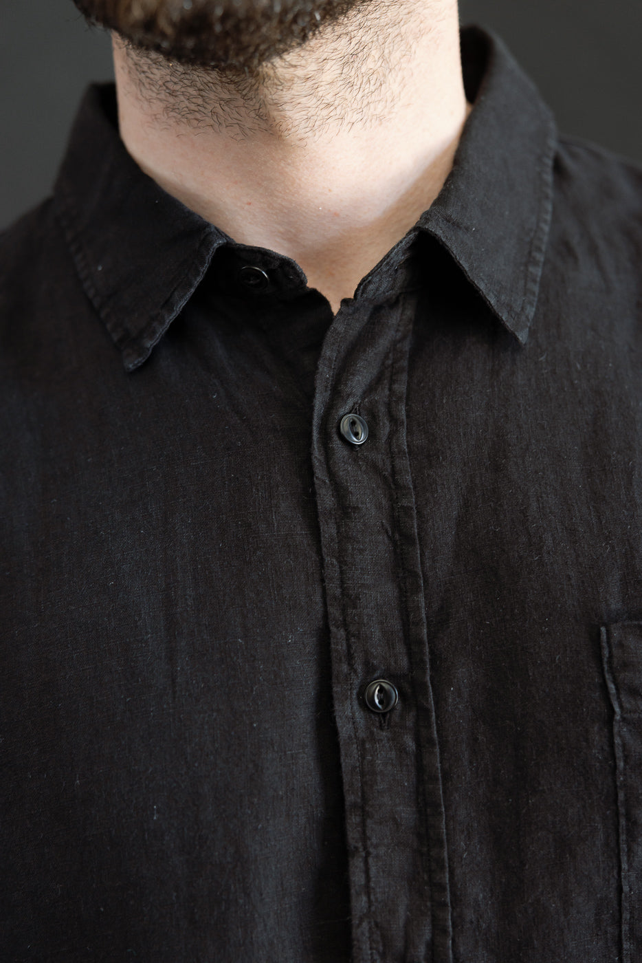 The SHIRT20LI.99 - Organic Linen Long Sleeve Shirt - Black features a button-front design, classic collar, and chest pocket, embodying a relaxed fit in premium organic linen.