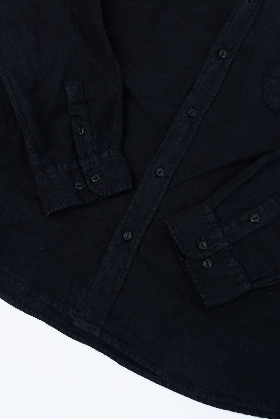 SHIRT20LI.99 - Organic Linen Long Sleeve Shirt - Black, featuring a button-up front, chest pocket with swan embroidery, and side slits, laid flat showcasing its airy, cropped fit and traditional craftsmanship.