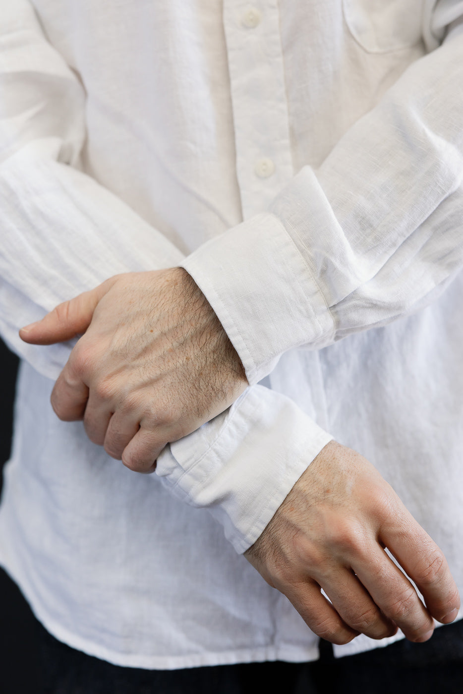 Close-up of front shirt cuffs and sleeves on male model, 5'9