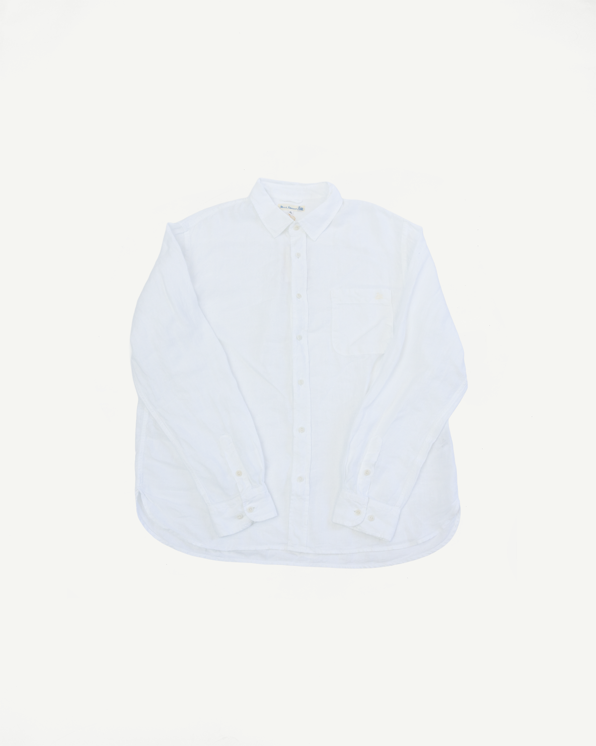 Flat lay, front view of white organic linen long sleeve shirt with button-down collar and chest pocket.