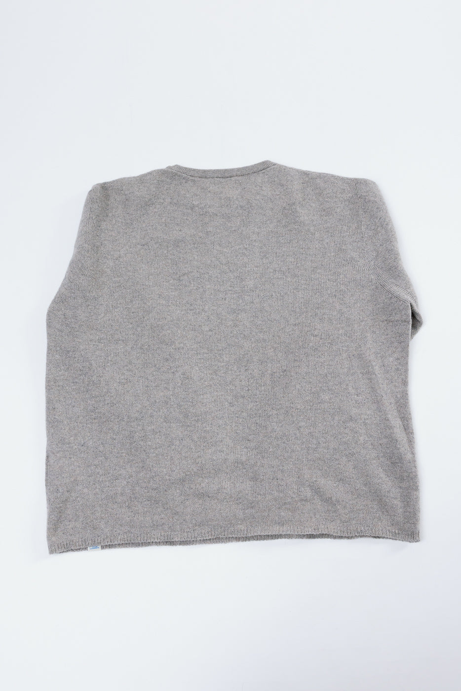 Back view flat lay of a grey textured knit sweater.