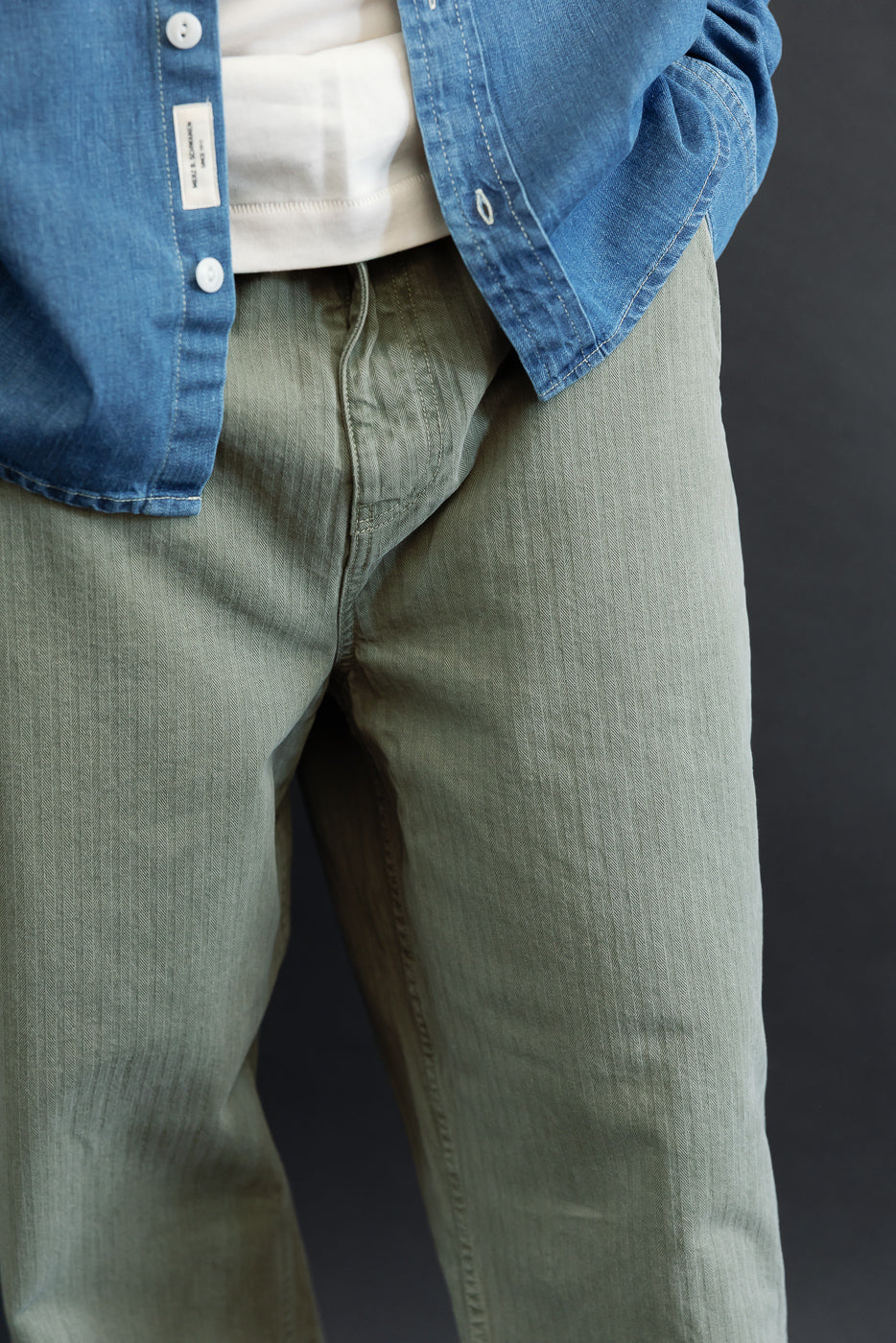 Close-up front view of olive green casual trousers on a 5'9