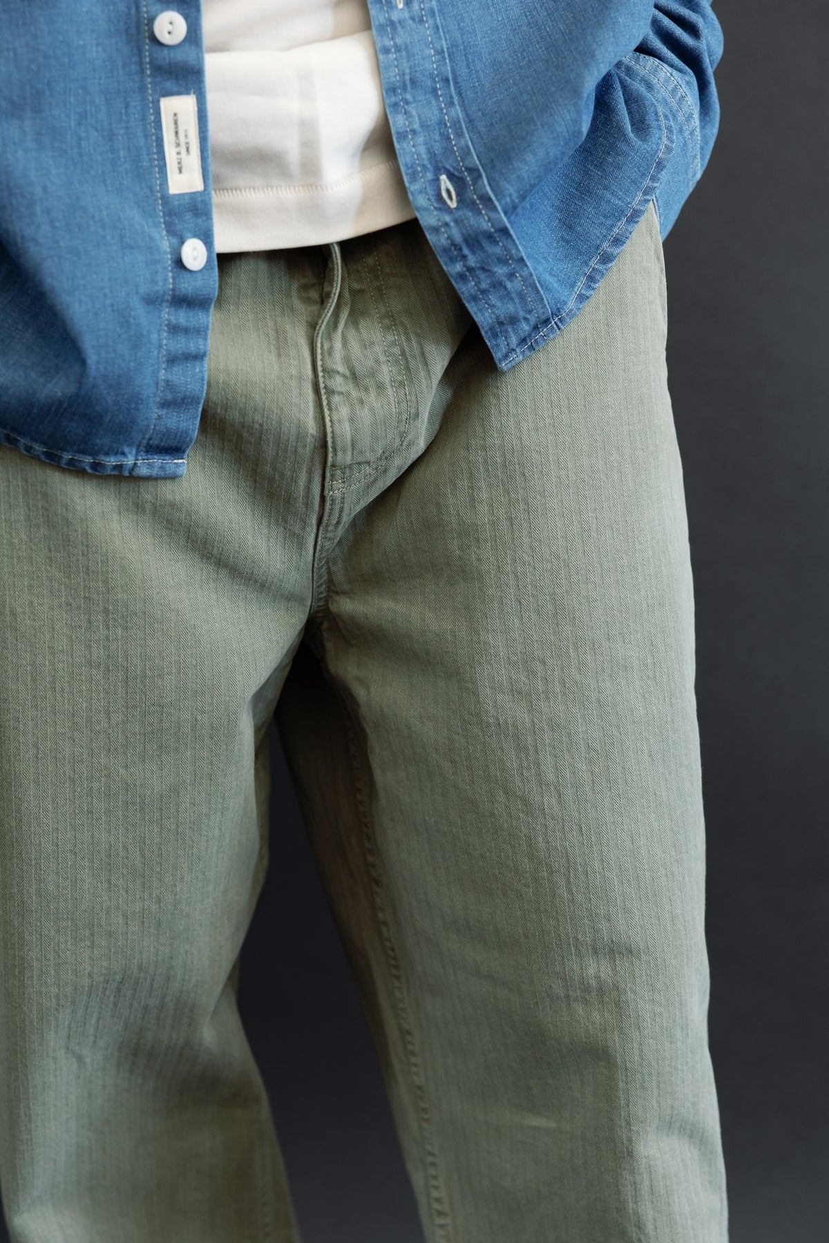 Close-up front view of olive green trousers on a 5'9