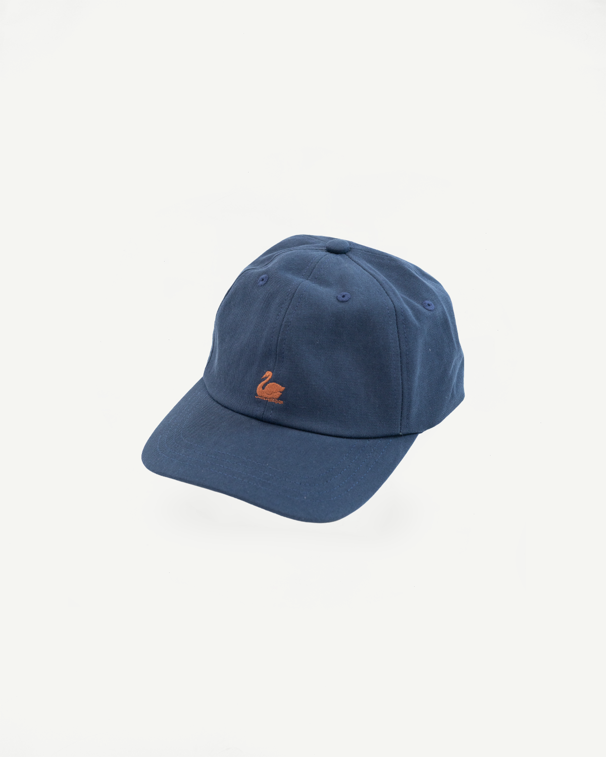 Front view close-up of a blue cotton baseball cap with an orange swan embroidery.
