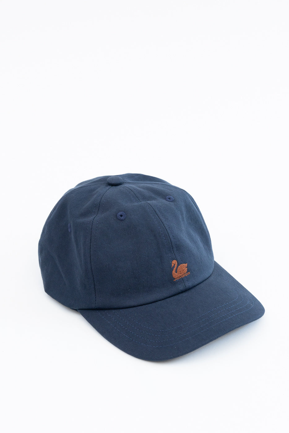 Front view of a navy blue cotton baseball cap with an orange swan embroidery detail.