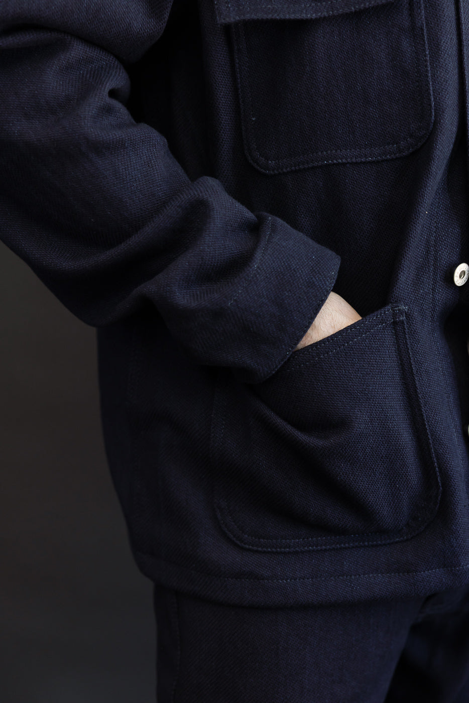 Close-up side view of navy chore jacket, male model 5'9