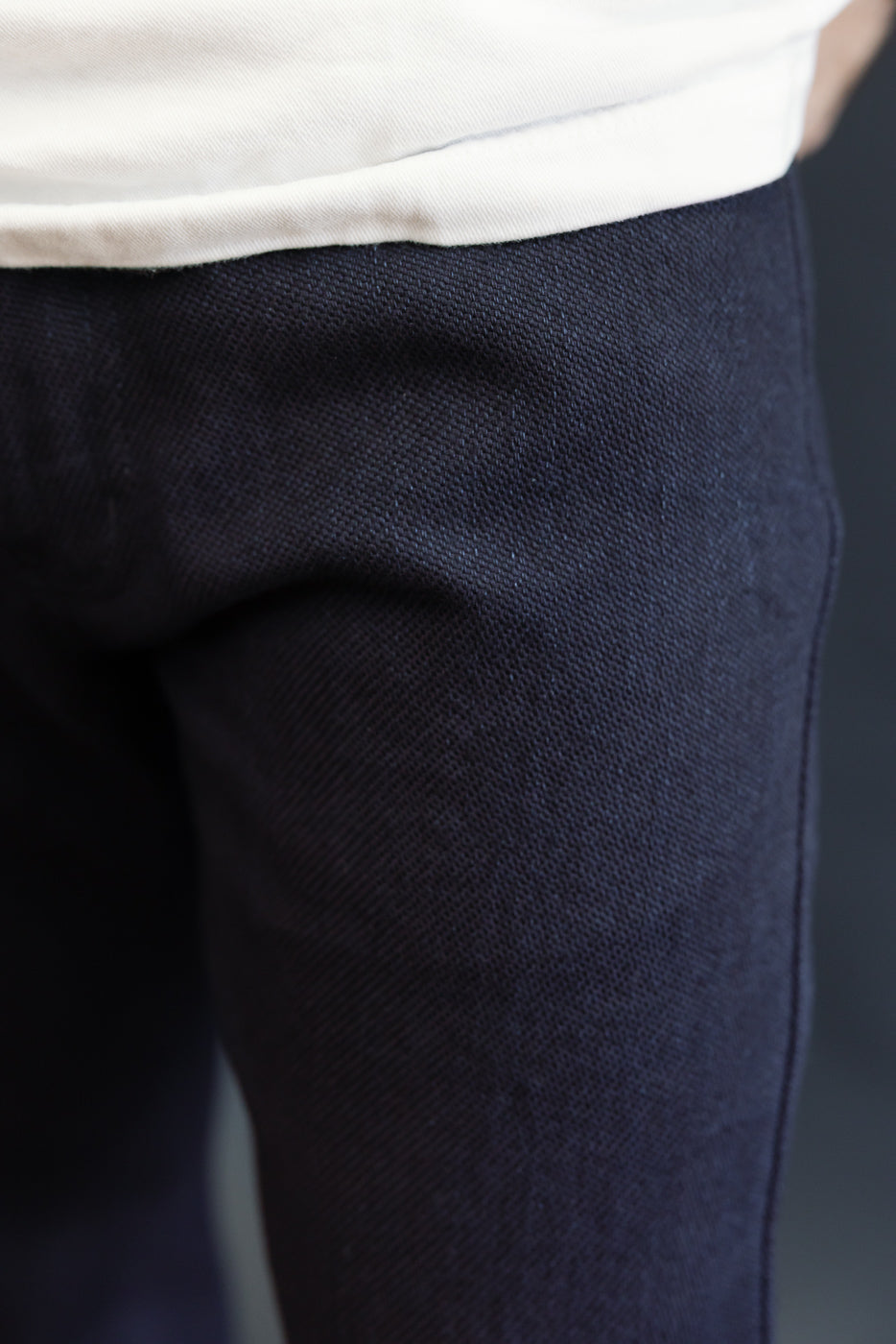 Close-up side view of dark navy selvedge denim pants on male model, 5'9