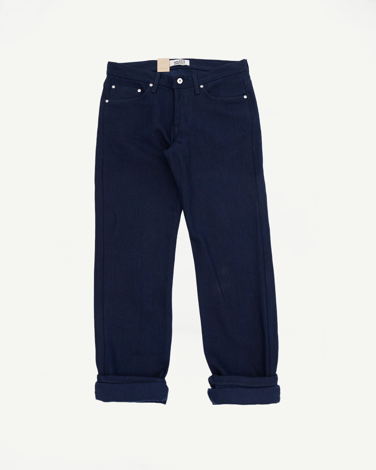 Front view of navy selvedge jeans with cuffed hems, silver rivets, and button fly