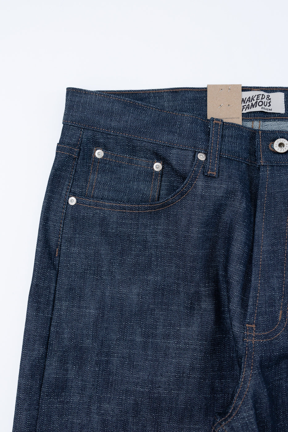 Close-up of 12.5oz - Greencast Stretch Selvedge - Strong Guy jeans, highlighting the front pocket with rivets, waistband, belt loop, and Naked & Famous Denim tag, showcasing Japanese selvedge craftsmanship.