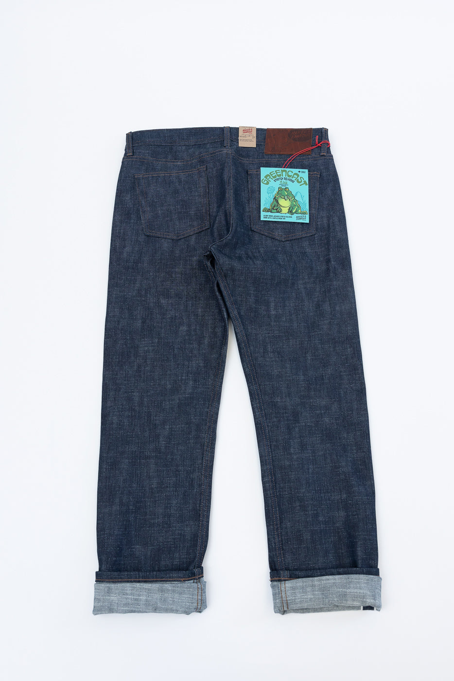 12.5oz Greencast Stretch Selvedge - Weird Guy jeans shown flat from the back, with rolled cuffs revealing the selvedge edge. Features include belt loops, back pockets, and a GREENCOAST tag.
