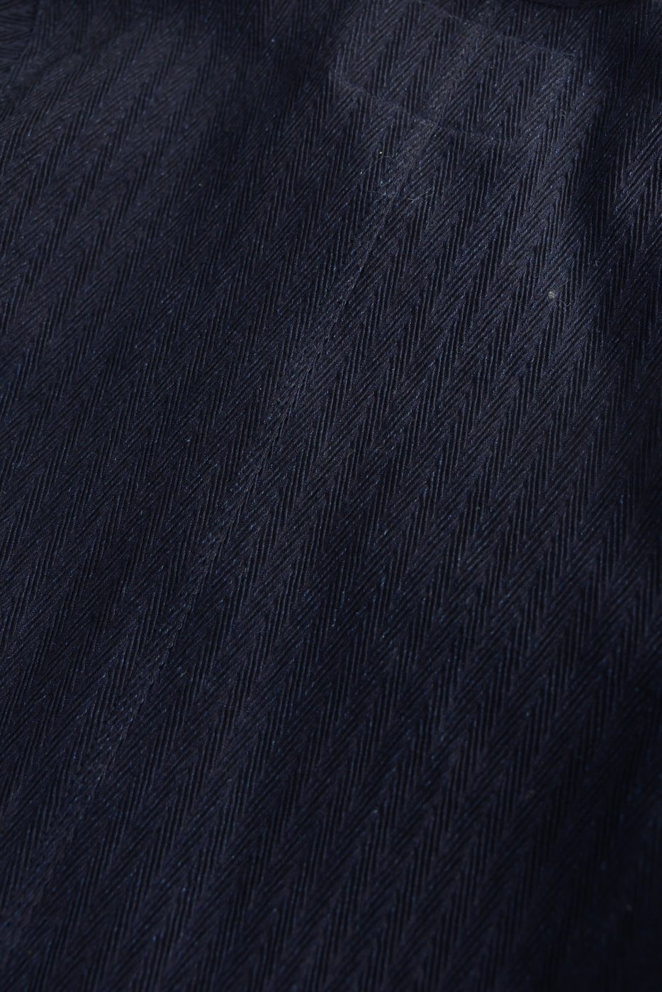 Close-up of Naked & Famous Indigo Sugiaya chore coat front fabric, herringbone texture