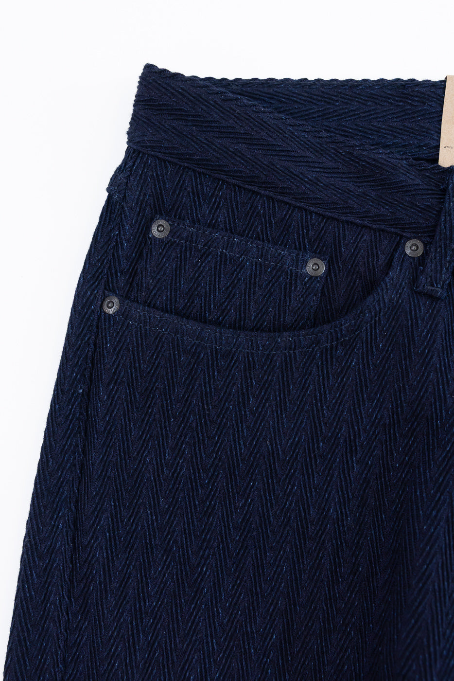 Close-up of front left pocket and textured indigo selvedge denim on Naked & Famous jeans.