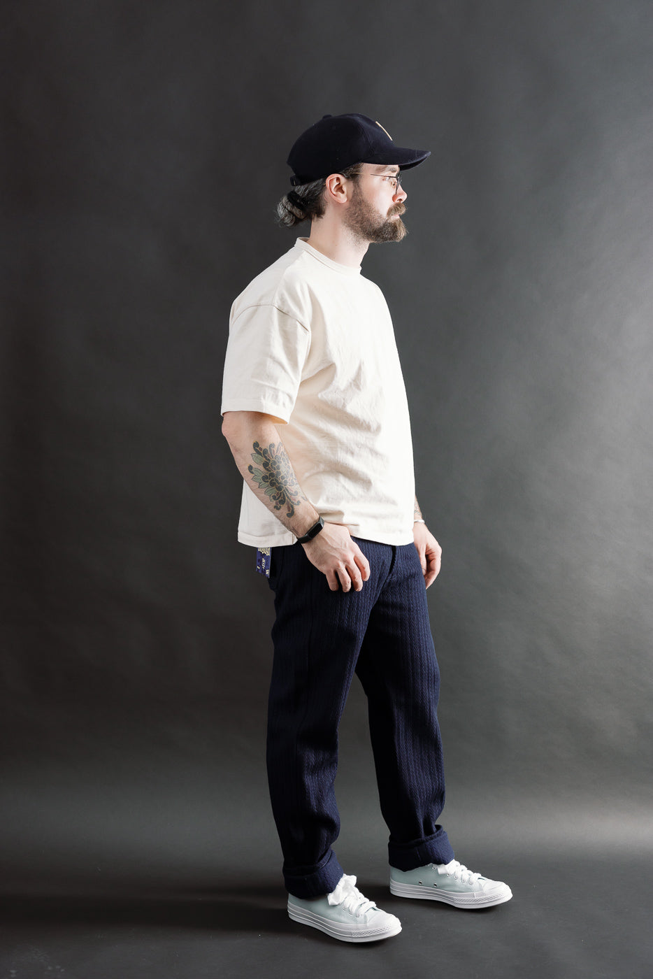 Male model 5'9 165lbs athletic build wearing Naked & Famous indigo jeans true guy fit, full body right side view