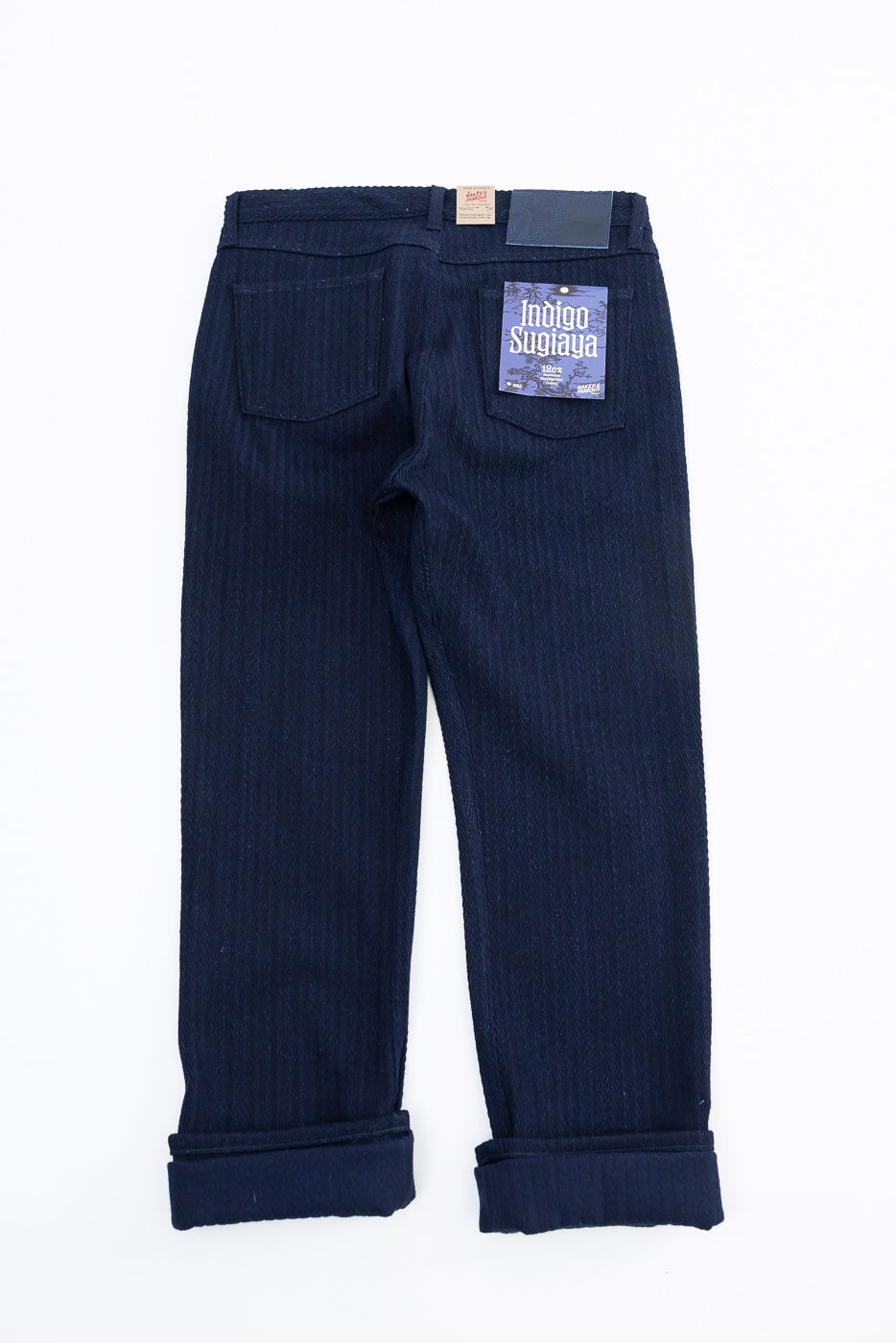 Flat lay of Naked & Famous 12oz Indigo Sugiaya Jeans, back view, showing rear pockets and label.