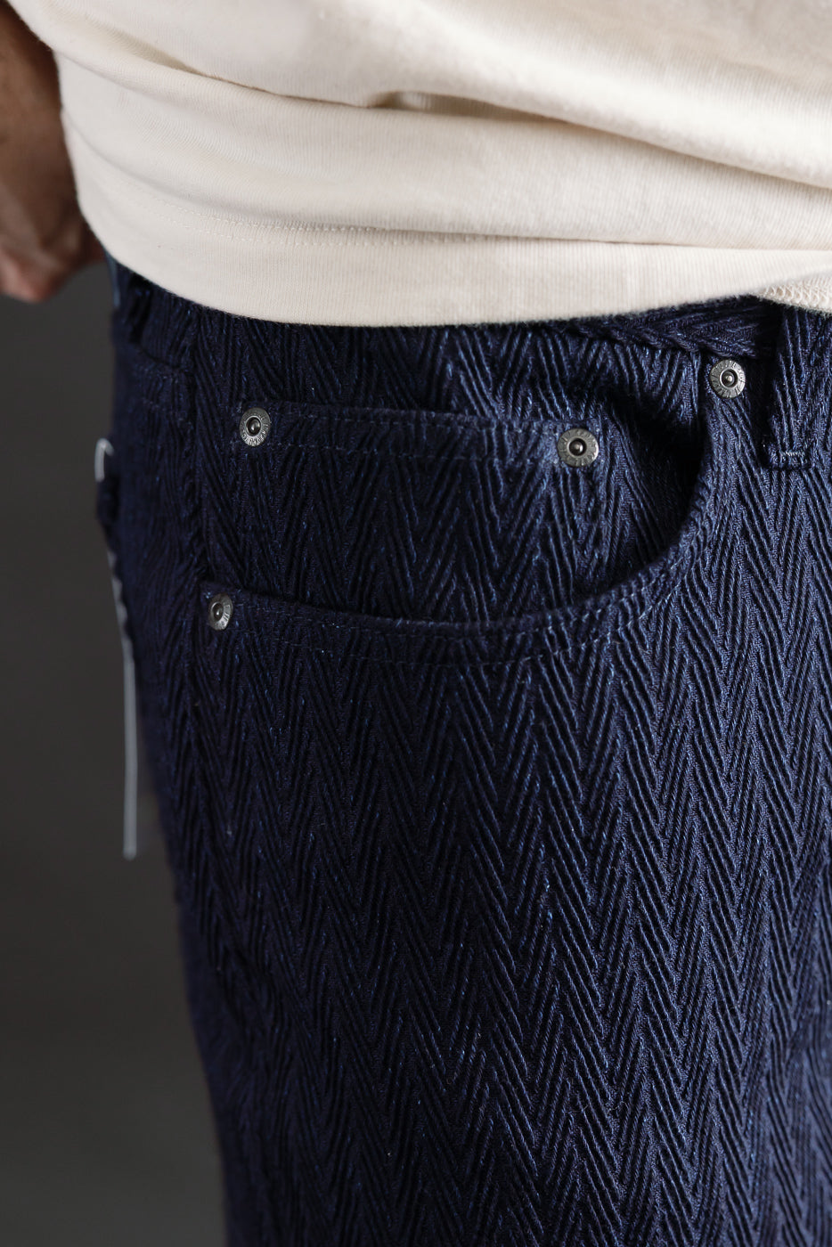 Close-up of front right pocket and textured indigo selvedge denim on male model, Dant