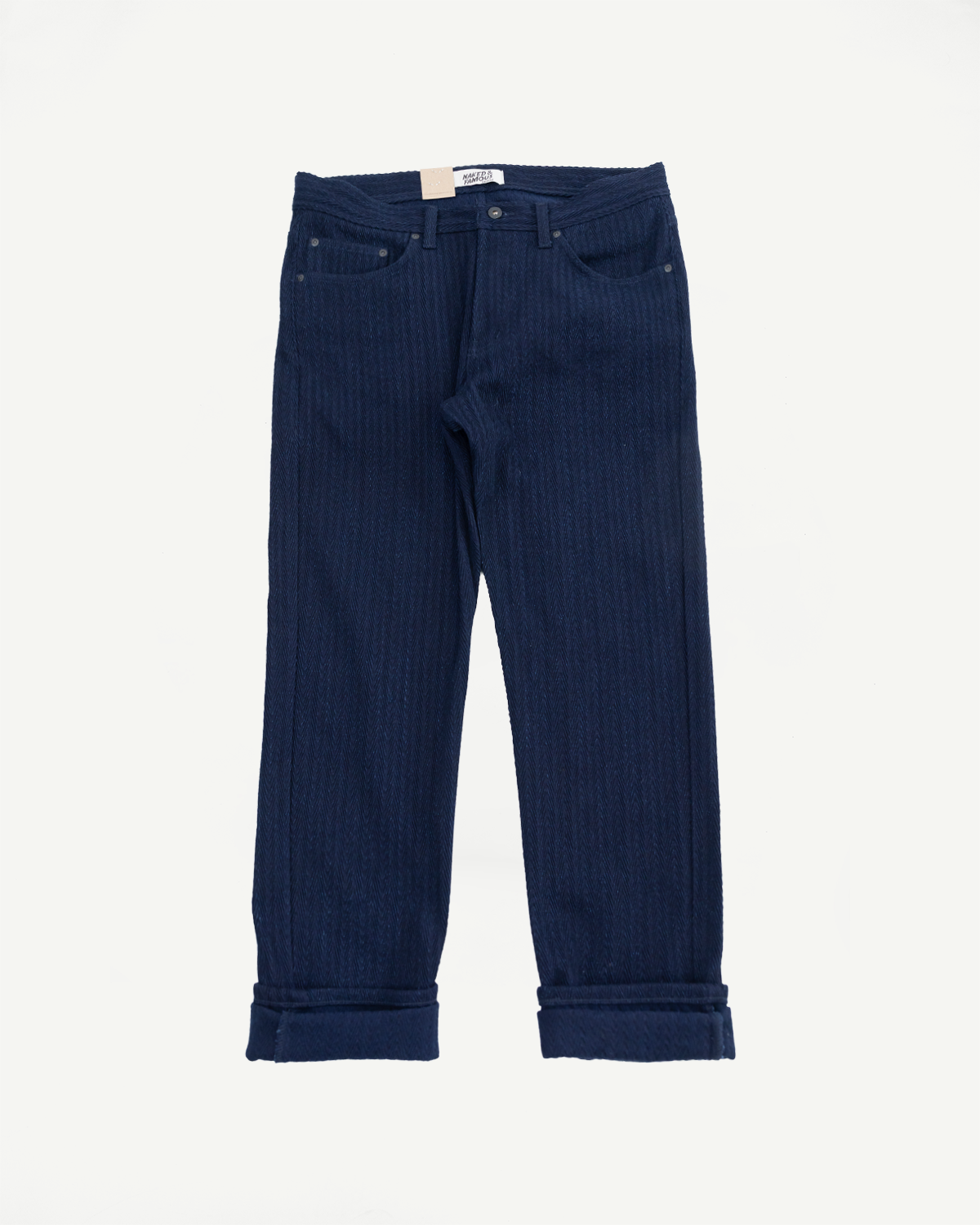 Flat lay front view of indigo selvedge jeans with cuffed hem and subtle textured fabric