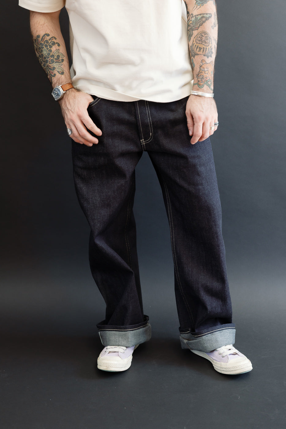 Front view of dark selvedge denim jeans on a male model, 5'9