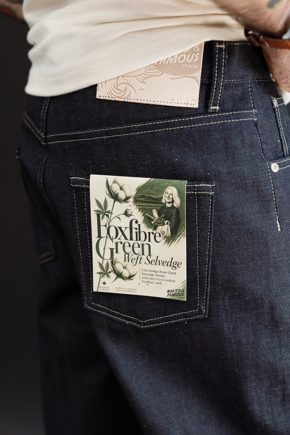 Close-up back view of dark indigo selvedge denim on male model, 5'9