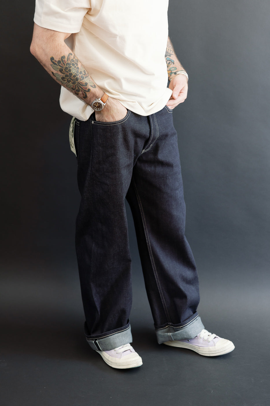 Front view of dark selvedge denim jeans on a 5'9