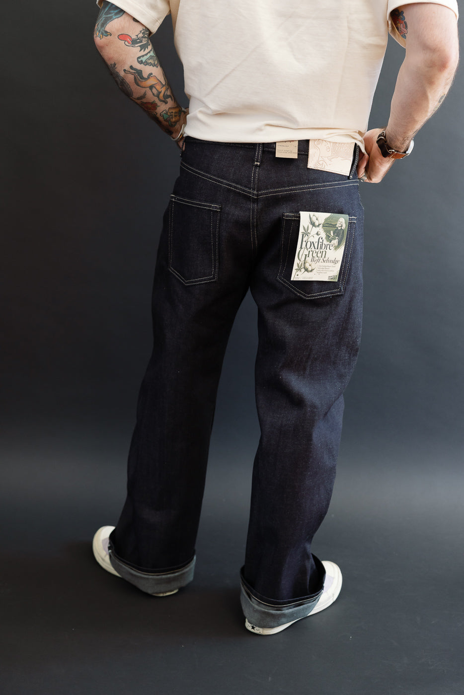 Back view of dark selvedge jeans on a male model, 5'9