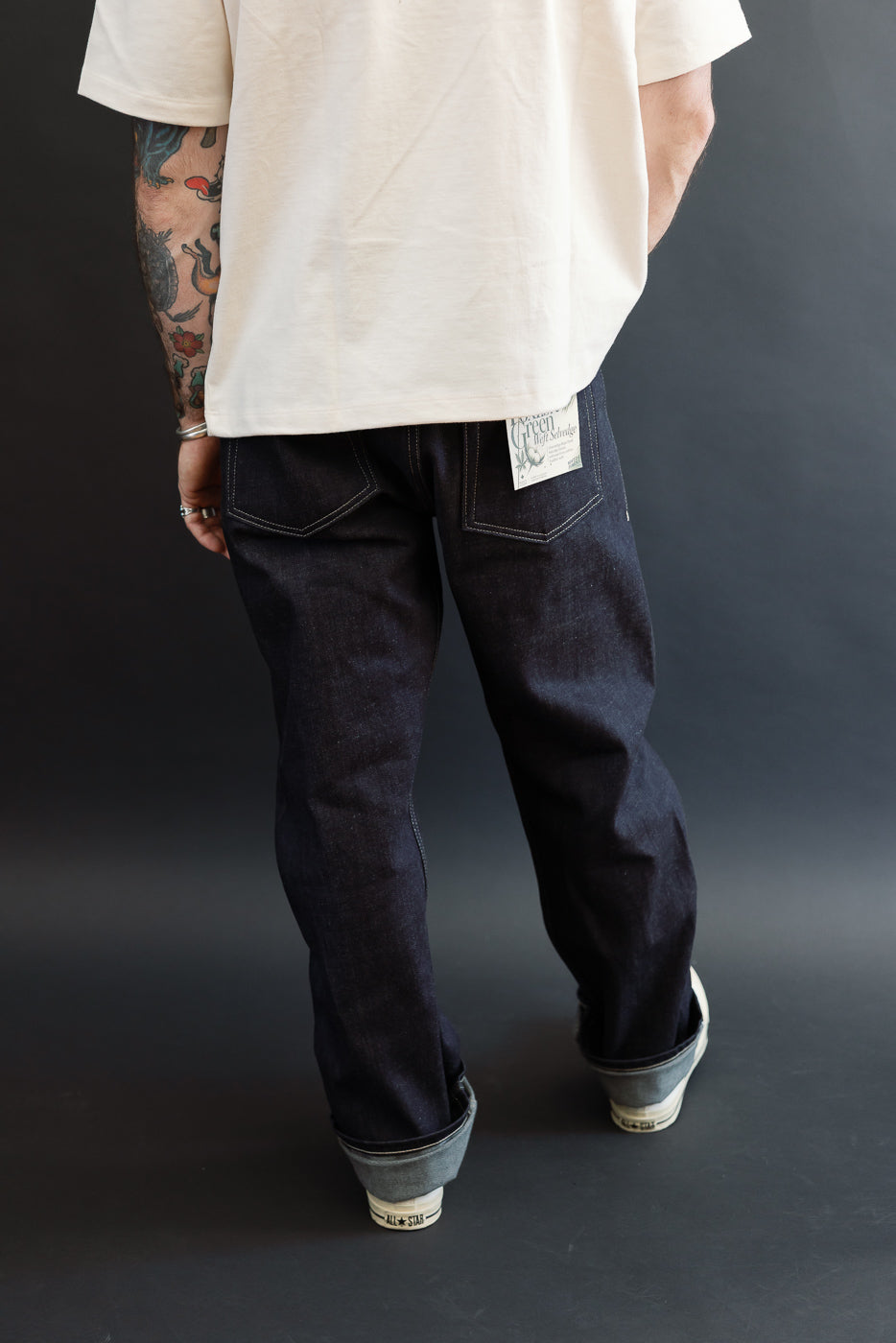 Back view of raw selvedge denim jeans on a male model, 5'9