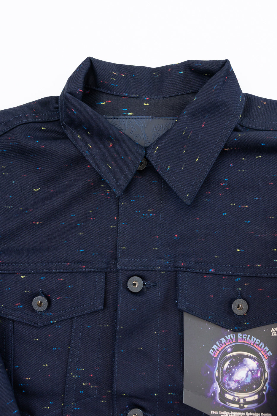 Close-up front view of navy galaxy selvedge denim jacket showing fabric texture and chest pockets.