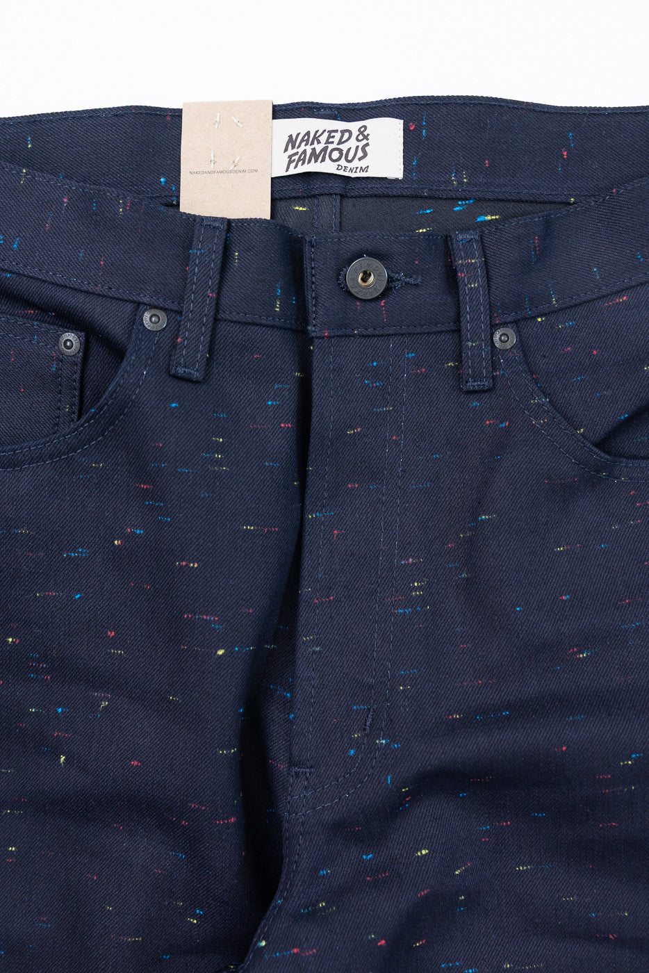Close-up front view of navy denim pants showing waistband, button, and fabric texture.