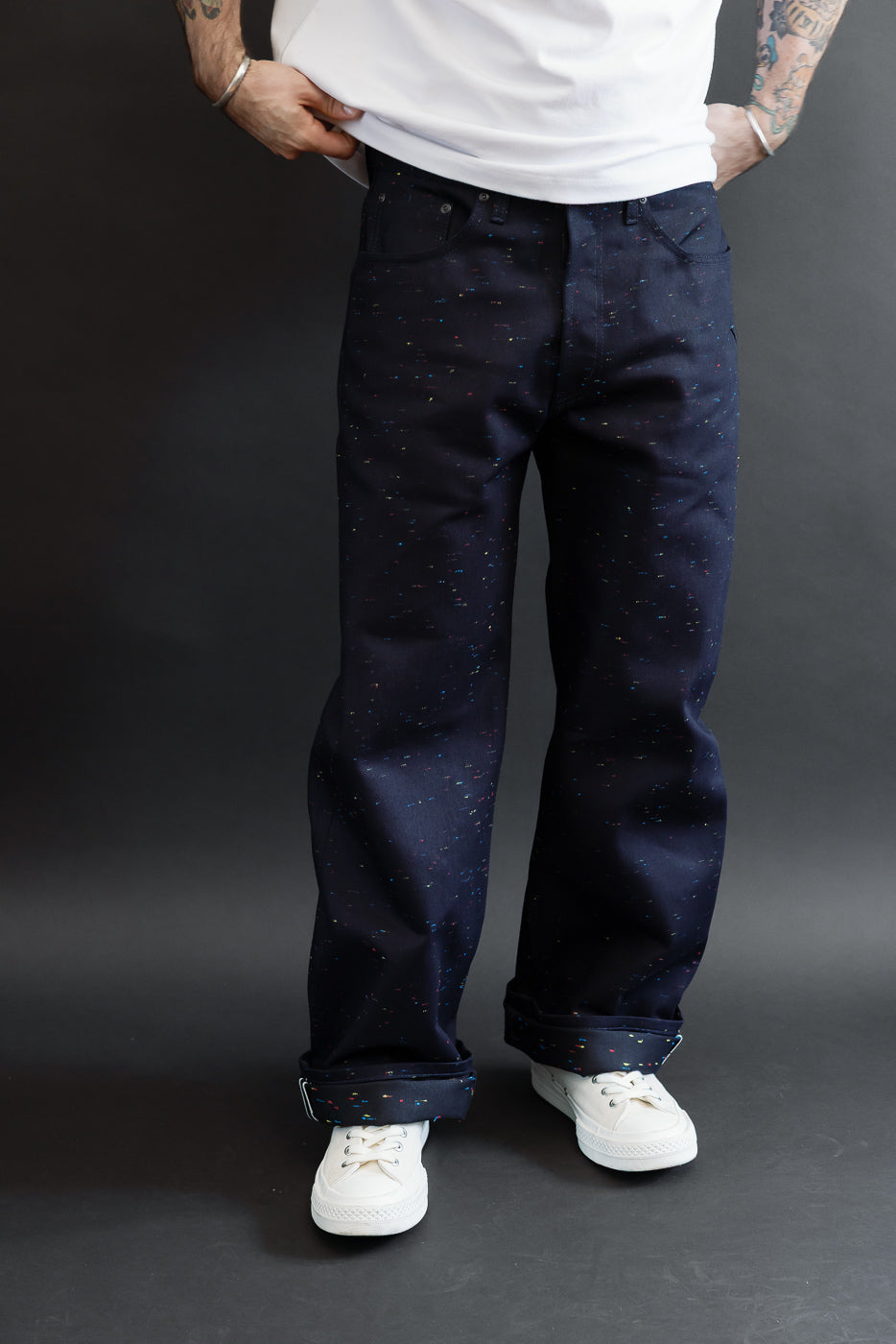 Front view of navy speckled jeans on a male model, 5'9