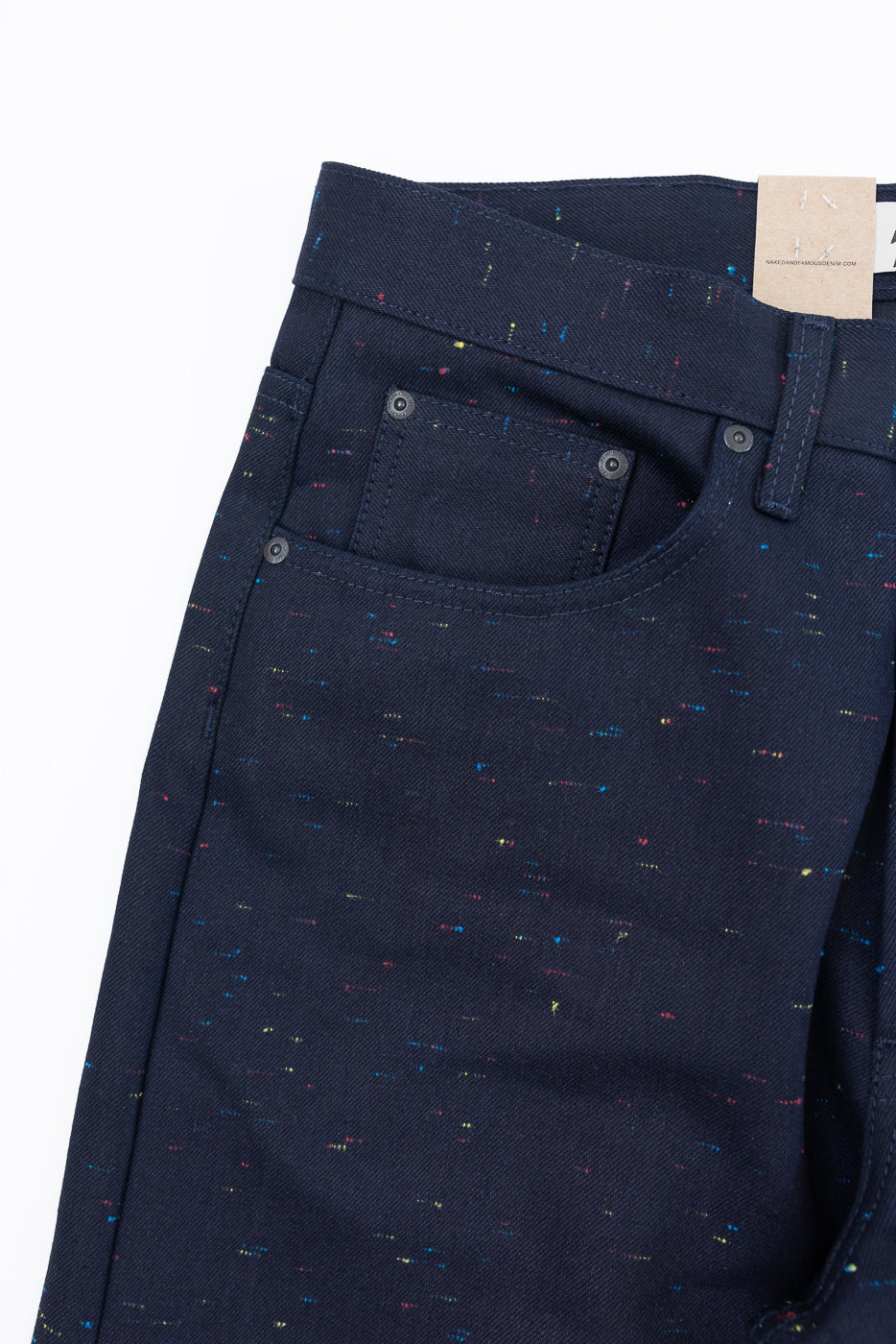 Close-up front view of navy blue speckled denim pants showing pocket and waistband detail.